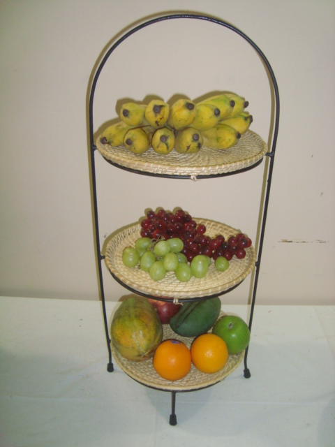 Fruit holder containing three cane baskets stacked on top of each other, held together by a metal frame